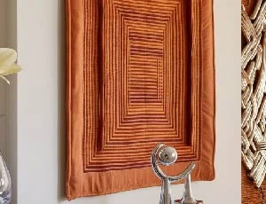 an image of traditional wall art along with modern decorative items beside the wall